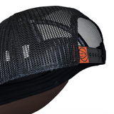 Trucker cap back panel with black mesh and orange brand tab on strap