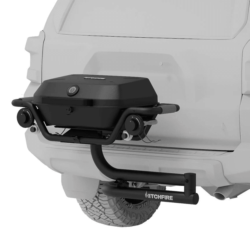Hitch-mounted propane grill with black lid and control knobs, HITCHFIRE branding