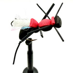 Novelty foam fly fishing lure with red foam body, white tuft, and black legs