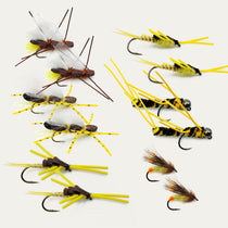 Assorted fly fishing lures on hooks with yellow and dark fuzzy wings