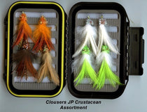 Crustacean lure assortment with orange and white/green feather jigs in cases
