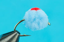 Glo Bug lure with blue fuzzy body and red dot, metal hook with wire shank