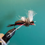 Feather streamer fly with marabou tail and red thread wrap, barbed hook