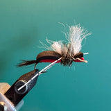 Feather streamer fly with marabou tail and red thread wrap, barbed hook