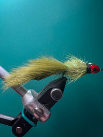 Olive leech fishing fly with fuzzy tail and red eye