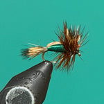 Dry fly fishing lure with green foam body and brown feather hackle on an eye hook