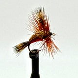 Dry fly fishing lure with red foam body and brown feather hackle on an eye hook