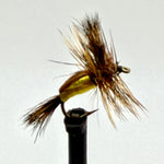 Dry fly fishing lure with yellow foam body and brown feather hackle on an eye hook