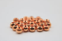 Round tungsten beads with countersunk holes, copper-colored finish
