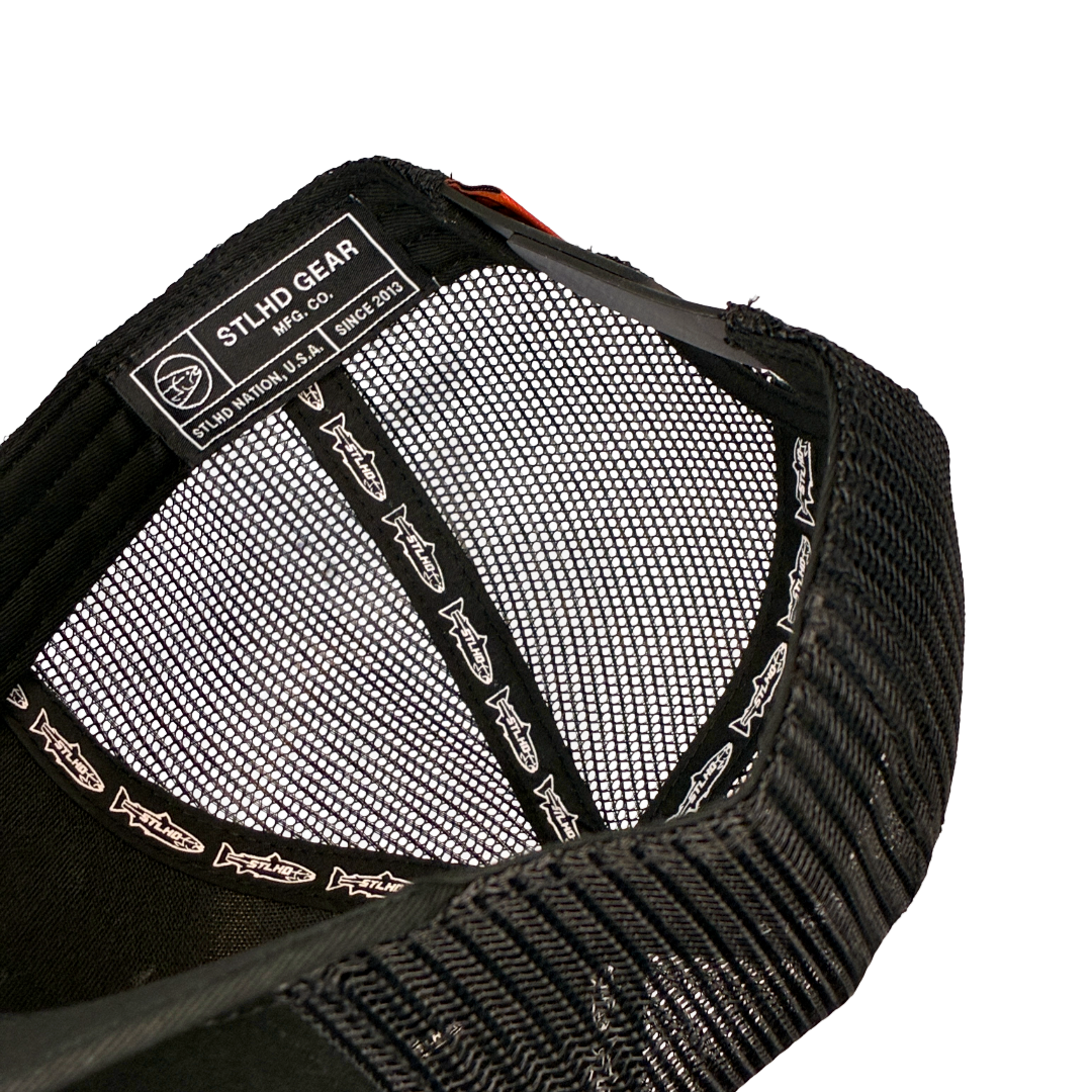 Black STLHD trucker cap showing interior mesh and stitched lining