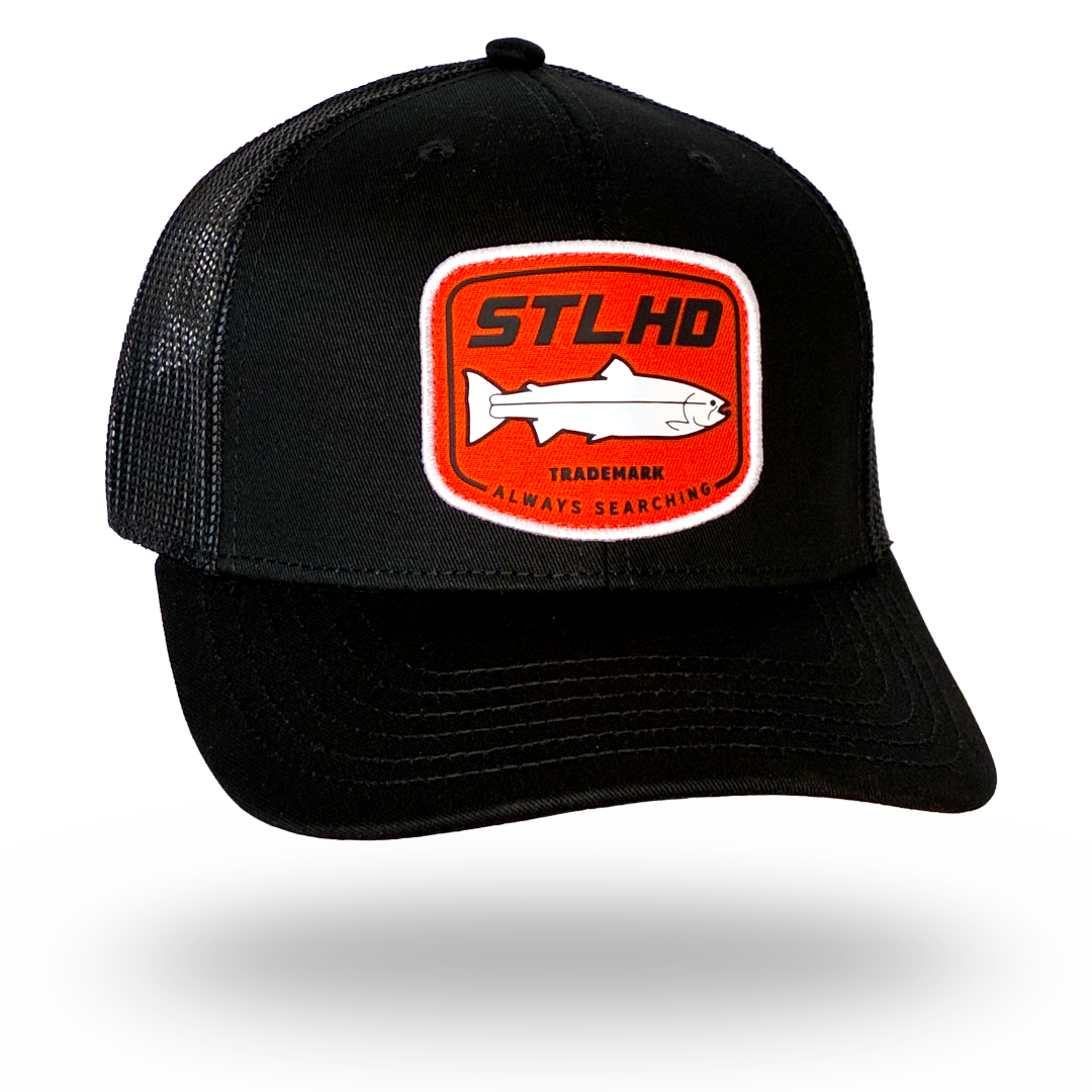 Black STLHD trucker cap with front patch logo and orange-trim details