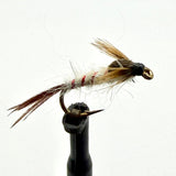 Brown feather fishing fly with red thread accents and gold hook