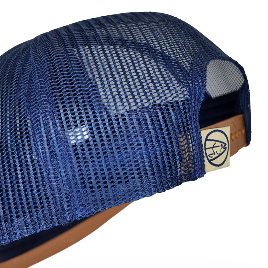 Blue mesh trucker cap with side panel and brown leather logo patch