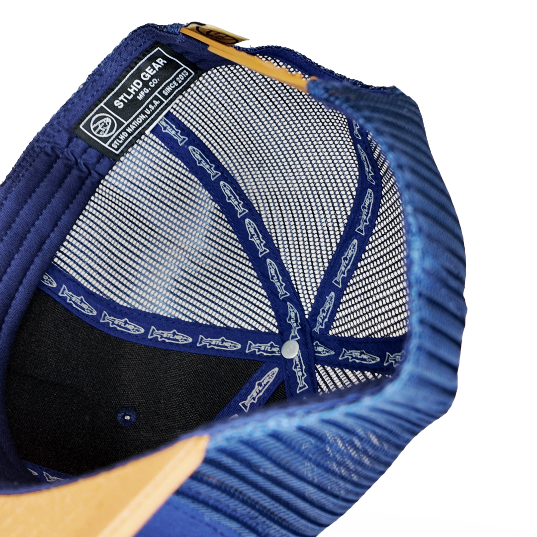 Blue trucker cap interior mesh with size tag and stitched emblem