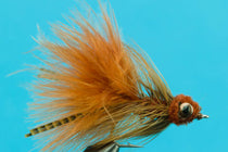 Mini Diablo crab fly with orange-brown feather body and dark bead eyes