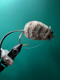 Gray fuzzy felt mouse lure on curved hook with hair tail