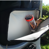 Black storage panel pocket holding bottled drinks and other small items