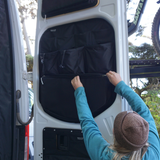 Black door-mounted storage panel with pockets on an open Mercedes Sprinter rear door