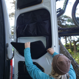 Black rear door storage panel with large pocket and divider sections, door open