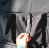 Black storage panel pockets with zipper pull tab and tie strap detail