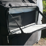 Black open zippered storage compartment on rear door panel with strap and lining