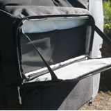 Black open zippered storage compartment on rear door panel with strap and lining