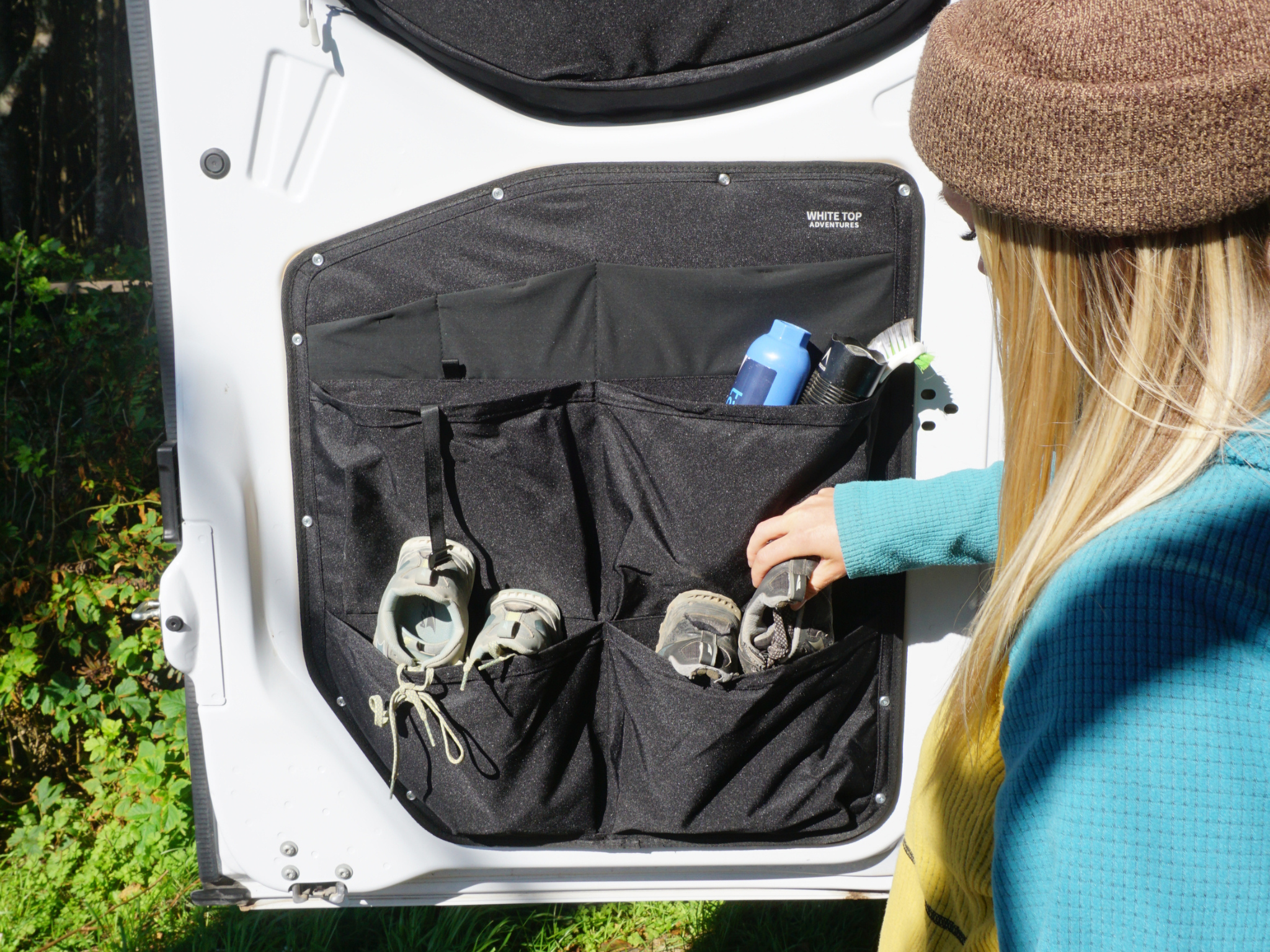 Black rear door storage organizer with zip pockets and bottle-sized holders
