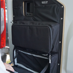 Black rear door storage panel with large zip pocket and two smaller compartments