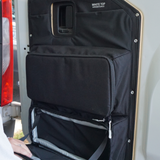 Black rear door storage panel with large zip pocket and two smaller compartments