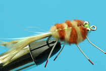 Brown fuzzy crab-style fly with hook, bead eyes, and long legs