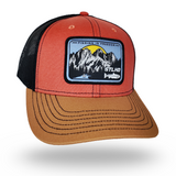 Red and tan trucker cap with black mesh sides and front logo patch