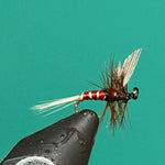 Black fishing spinner lure with red bead, wire body, and feather tail