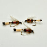 Set of three wet fishing flies with gold-brown bodies, red bands, and feathered wings