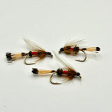 Set of three wet fishing flies with gold-brown bodies, red bands, and feathered wings
