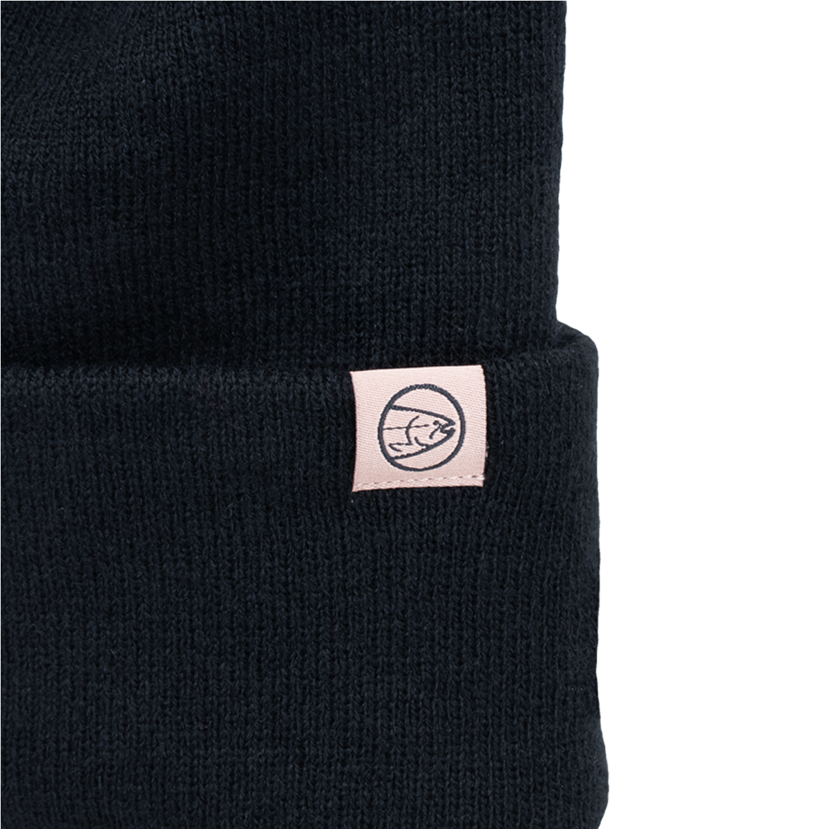 Black knit beanie with small rectangular patch and circular emblem on cuff