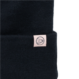Black knit beanie with small rectangular patch and circular emblem on cuff