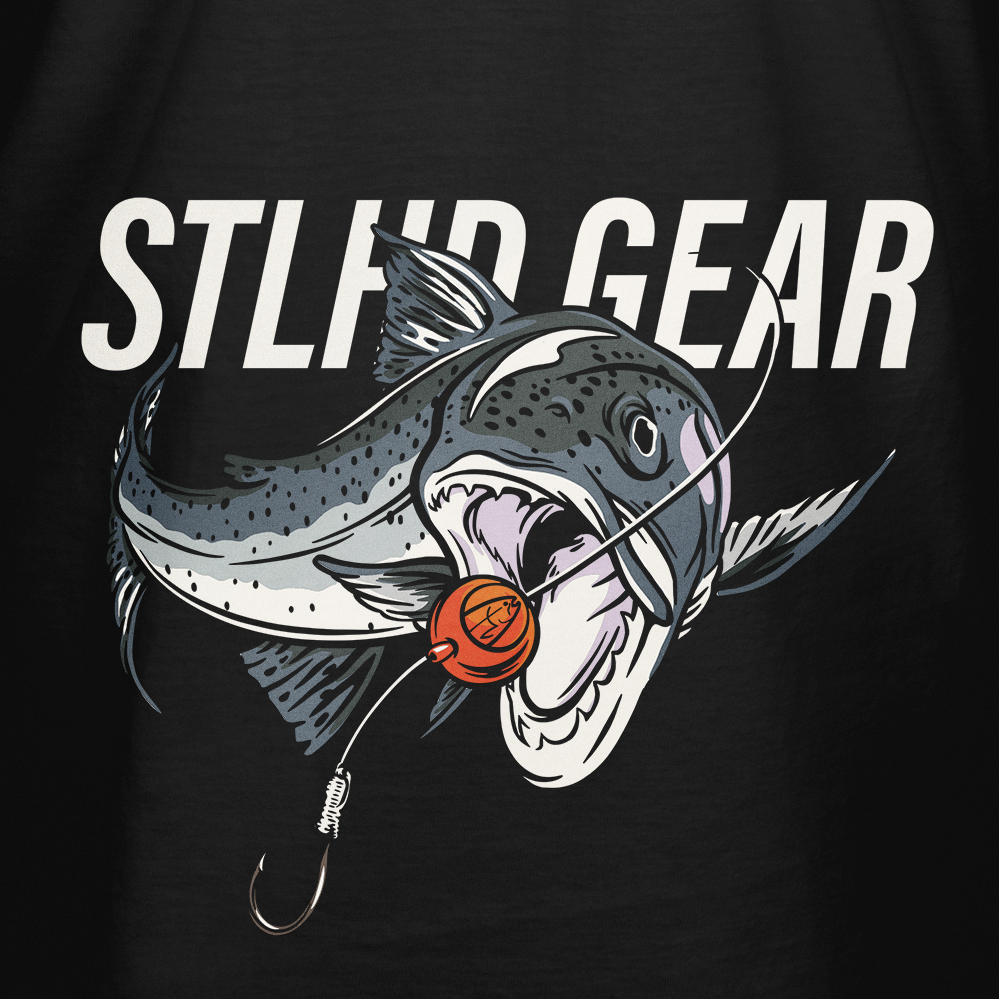 Black T-shirt close-up: STLHD GEAR lettering with fish head and orange lure