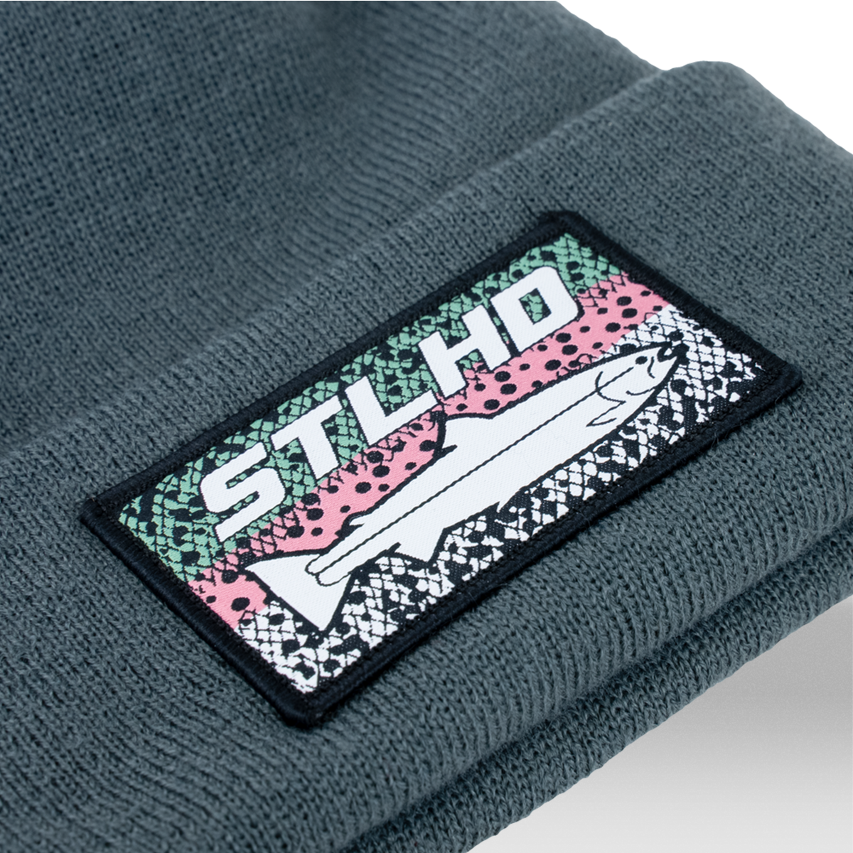 Dark teal knit beanie with ribbed cuff and stitched STLHD logo patch