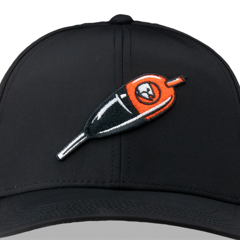 Black trucker cap close-up with orange embroidered logo and curved brim