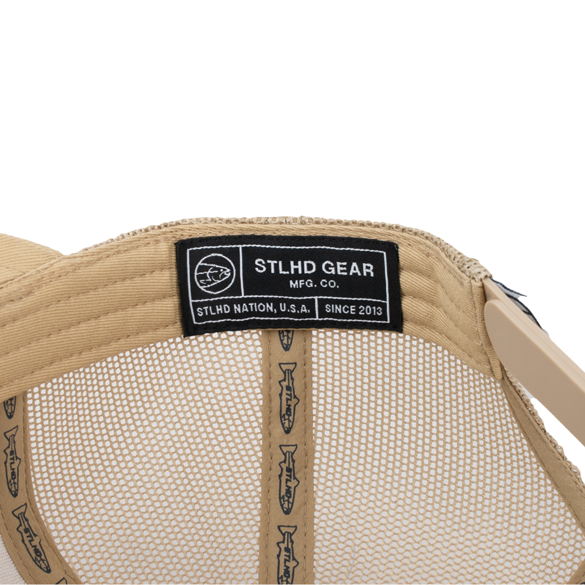 Beige mesh trucker cap showing interior StLHD Gear label and straps