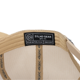 Beige mesh trucker cap showing interior StLHD Gear label and straps