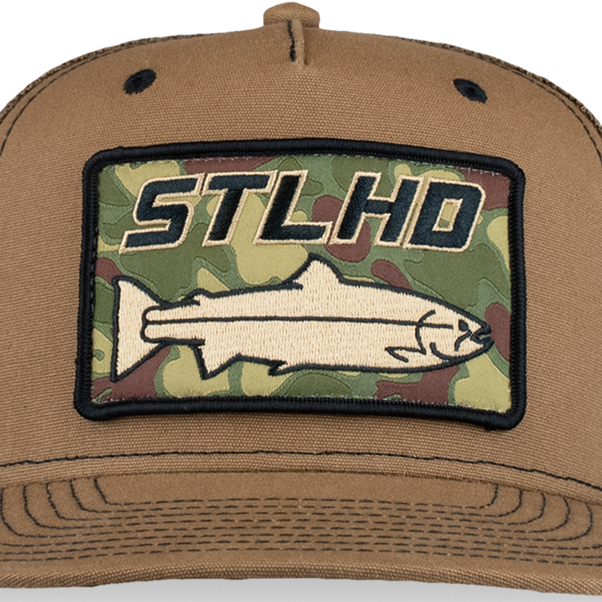 Tan trucker cap close-up of front ST LHD camo logo patch on curved brim