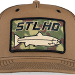 Tan trucker cap close-up of front ST LHD camo logo patch on curved brim