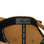 Black-lined cap interior with STLHD Gear MFG Co label and adjustable strap