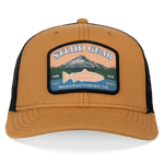 Wheat and black trucker cap with large front logo patch and curved brim