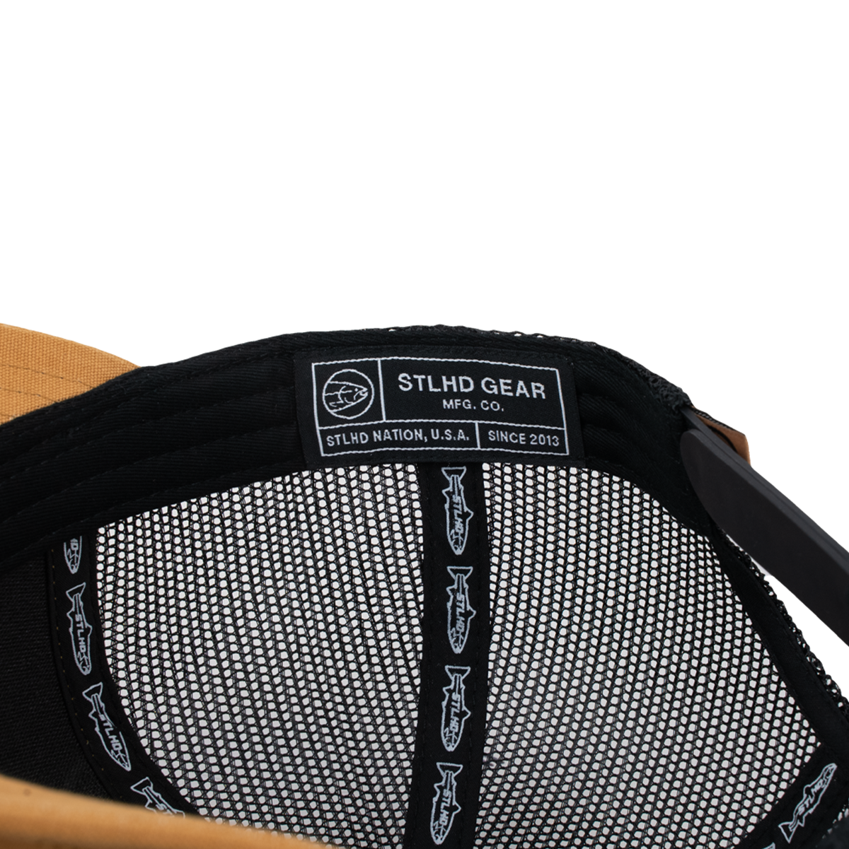 Black mesh trucker cap interior with white brand label and logo pattern