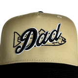 Close-up khaki dad hat with embroidered 'Dad' lettering and bow graphic