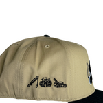 Back view khaki dad hat with small stitched text and embroidered icon