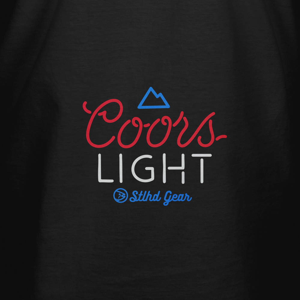 Men's black graphic T-shirt close-up of Coors Light chest logo in red, white, blue
