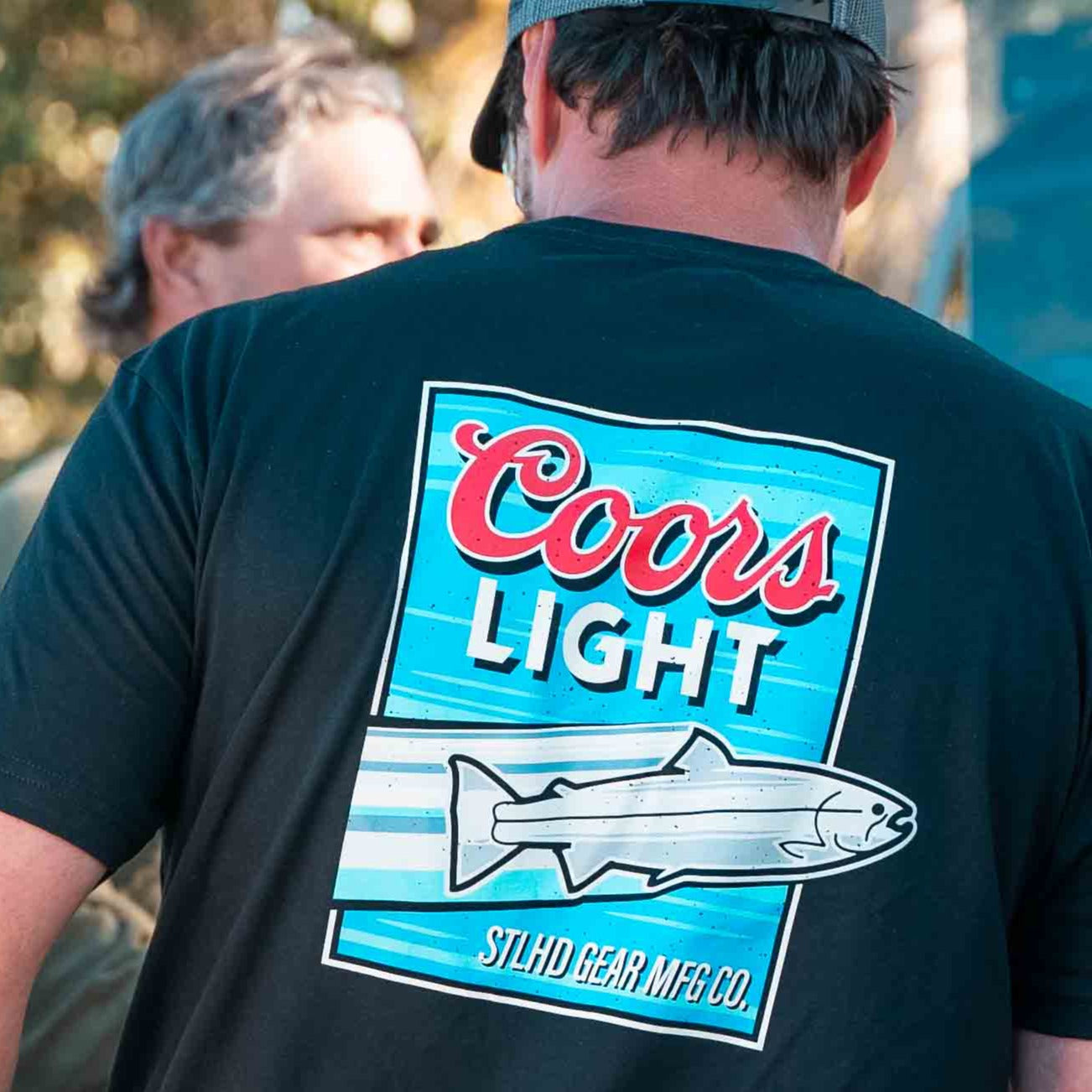Men's black T-shirt with large back Coors Light fish logo, worn by model